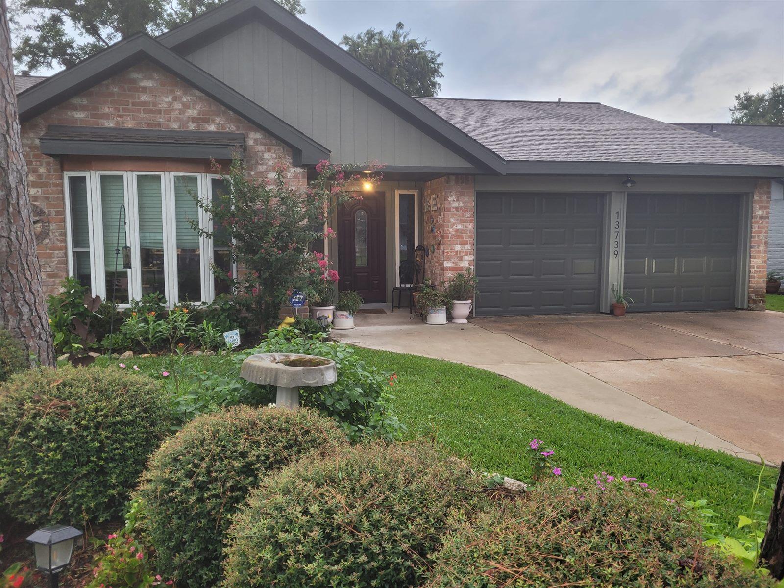 Updated home exterior with fresh paint and landscaping at dusk